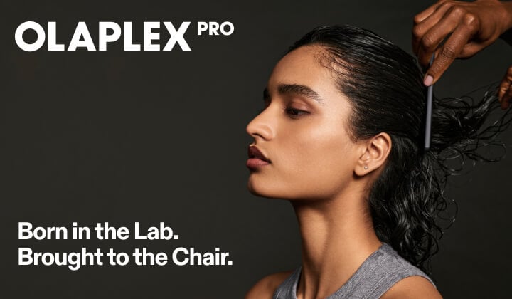 Olaplex hero image showing a stylist applying Olaplex treatment to a client's hair in a salon setting